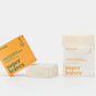 ATTITUDE’s super leaves Shampoo Volume & Shine Bar and Conditioner Bar come in yellow, plastic-free boxes with white bars. Both vegan products are displayed on a plain white background.