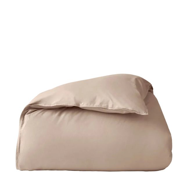 A neatly folded, light beige comforter sits against a plain white background, its texture reminiscent of the Coyuchi Organic Crinkled Percale™ Duvet Cover—perfect for pairing with this breathable bedding essential.