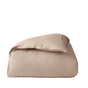 A neatly folded, light beige comforter sits against a plain white background, its texture reminiscent of the Coyuchi Organic Crinkled Percale™ Duvet Cover—perfect for pairing with this breathable bedding essential.