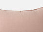 A close-up of the Coyuchi Organic Crinkled Percale™ Sham in light pink, displayed against a plain white background, highlights the top edge and the subtle texture of its breathable, crinkled percale fabric.