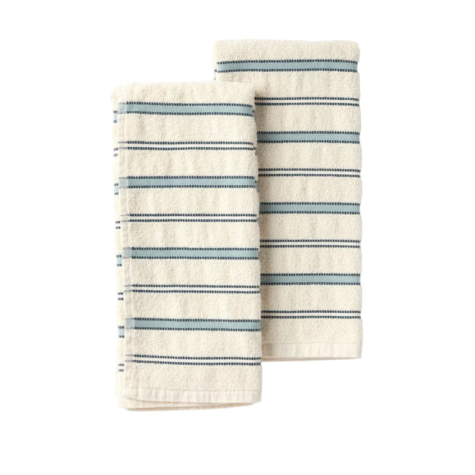 The Coyuchi Acacia Organic Hand Towel, Set of 2, features two cream-colored towels adorned with horizontal blue and black textured stripes, neatly folded and positioned side by side on a light gray background to highlight their stylish design and exceptional absorbency.