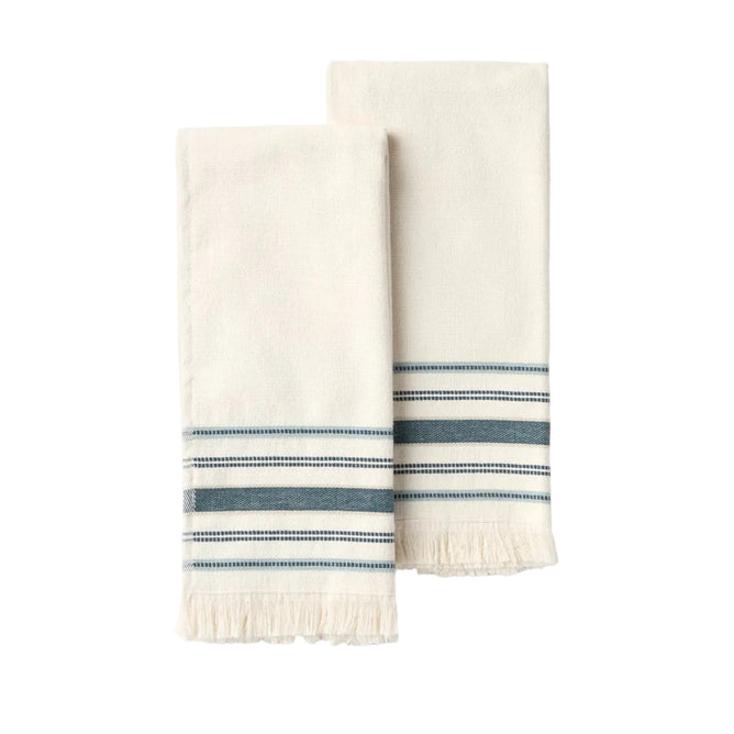 Two folded cream-colored Aptos Organic Hand Towels by Coyuchi, featuring blue and gray stripes with fringed edges, are placed side by side on a plain light background, creating an elegant set crafted from soft organic cotton.