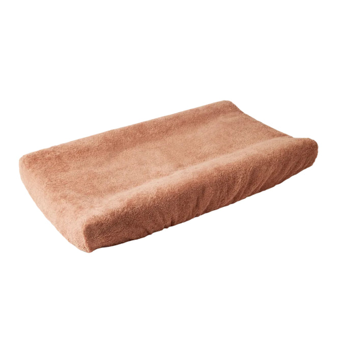 A soft, rectangular, brown Coyuchi Cloud Loom™ Organic Changing Pad Cover with curved, contoured sides is displayed on a plain white background.