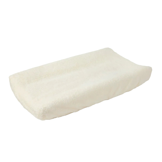 A Cloud Loom™ Organic Changing Pad Cover by Coyuchi, made of soft off-white terrycloth in a rectangular shape with gently raised edges, is displayed on a plain white surface.