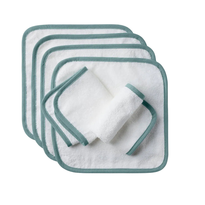 Six organic cotton Cloud Loom™ Baby Wash Cloths by Coyuchi are stacked neatly, with one washcloth rolled and placed on top. Ideal for baby care and gentle cleansing, the set is shown against a plain, light-colored background.
