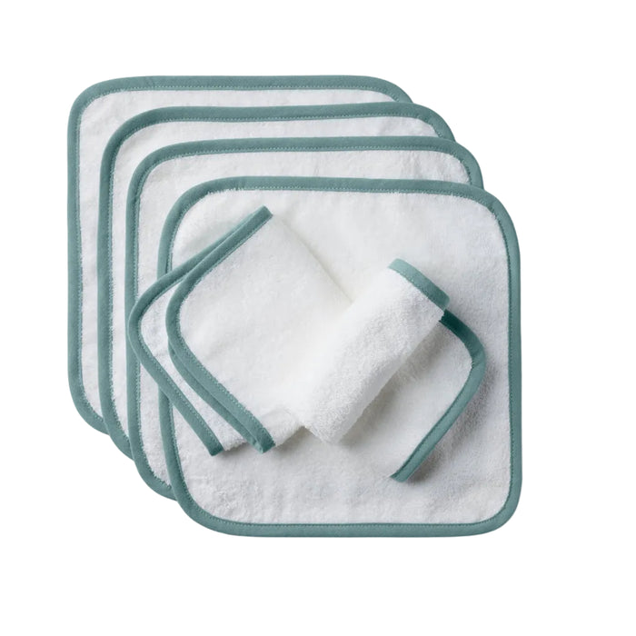 Six organic cotton Cloud Loom™ Baby Wash Cloths by Coyuchi are stacked neatly, with one washcloth rolled and placed on top. Ideal for baby care and gentle cleansing, the set is shown against a plain, light-colored background.