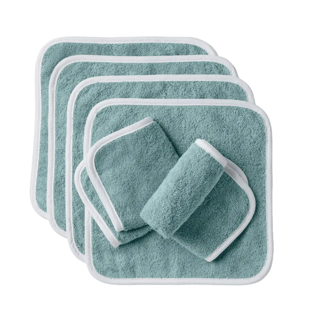 Six teal, square Cloud Loom™ Organic Baby Wash Cloths by Coyuchi, featuring white trim and crafted from ultra-soft organic cotton, are artfully displayed on a white background. Four washcloths are fanned out in a neat stack, while two are rolled and set in front—perfect for gentle baby care.