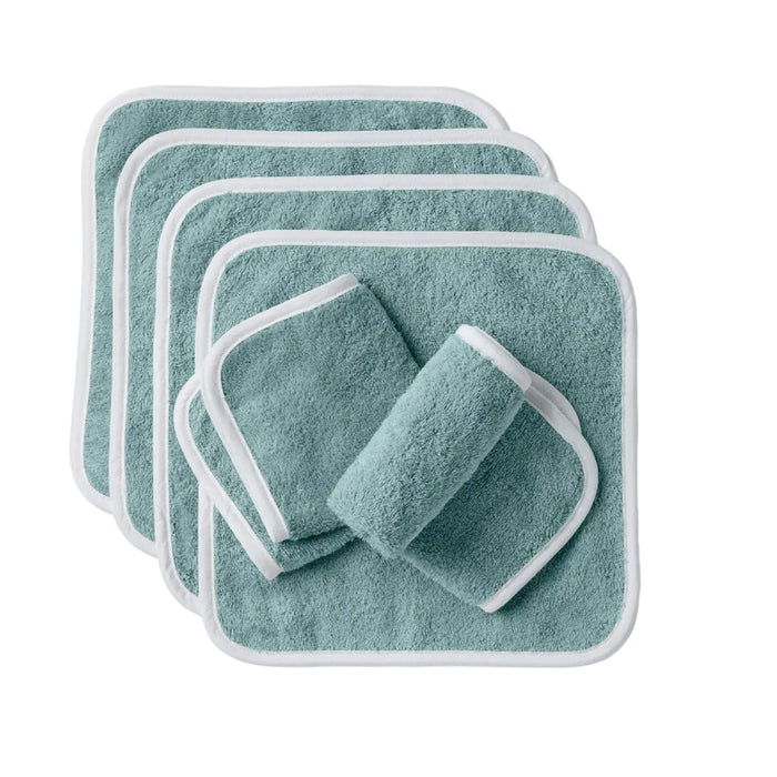 Six teal, square Cloud Loom™ Organic Baby Wash Cloths by Coyuchi, featuring white trim and crafted from ultra-soft organic cotton, are artfully displayed on a white background. Four washcloths are fanned out in a neat stack, while two are rolled and set in front—perfect for gentle baby care.