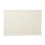 The Wildflower Organic Bath Rug by Coyuchi is a rectangular, off-white, textured absorbent bath mat featuring raised abstract patterns and a subtle border, shown on a white background.