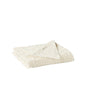 The Coyuchi Wildflower Organic Bath Towel, crafted from cream organic cotton with a tufted floral texture and fringe trim, is shown folded on a white background.