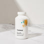 A white bottle of Thorne Super EPA rests on a marble surface. Its minimalist label features abstract yellow and blue artwork, highlighting this supplement’s support for heart health and joint wellness.