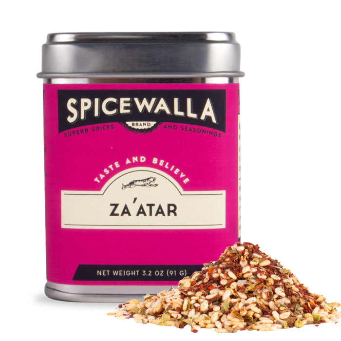 A tin of Spicewalla Za’atar, a Middle Eastern spice blend with sesame and sumac, sits next to a small mound of the mix. The magenta label adds to its vibrant look.