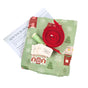 The Sew Your Own Set of 10 Gift Bags - Folk Art Cottages by Waste Free Celebrations includes green cottage-print fabric, green thread, red ribbon, labels, and instructions—ideal for Christmas crafts or reusable holiday gift bags.