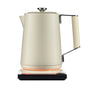 The Saki Luna Stainless Steel Electric Kettle Pro, in cream, features temperature control and a textured handle. It sits on a matching square base with an orange light, showing it’s powered on, against a white background.
