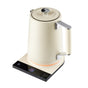 A modern cream-colored electric kettle with a digital display and touch controls, sitting on a black rectangular base with metallic accents and a textured handle.