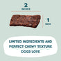 A rectangular Salmon Loves Butternut Jerky Dog Treat by Shameless Pets, sized 2x1, made with wild caught fish and limited ingredients for a chewy texture dogs love, is shown on a light green background.