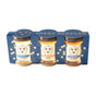 Three jars of Orange Blossom Honey, Acacia Honey, and Lavender Honey are presented in the Savannah Bee Company Honey Artisanal Sampler Set—a blue box with honeycomb designs. Each jar features a white label and a gold lid.