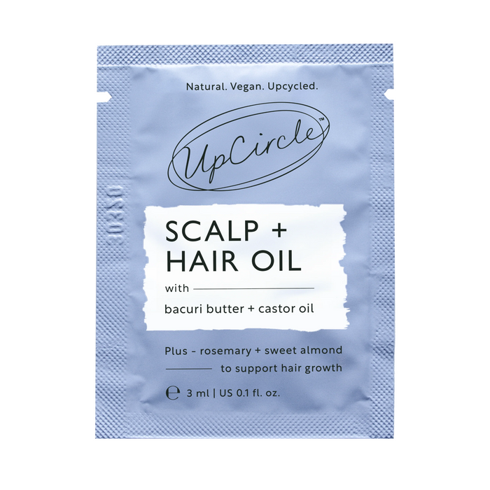 A 3 ml sachet of UpCircle Scalp + Hair Oil – Sample, formulated with bacuri butter, castor oil, rosemary, and sweet almond to support healthy hair growth. The text highlights that it is natural, vegan, upcycled.