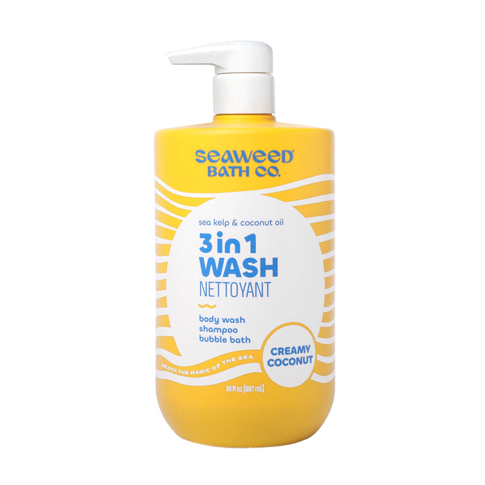A yellow 30 fl oz bottle of The Seaweed Bath Co. Value Size 3 in 1 Wash in Creamy Coconut scent, with a white pump dispenser, can be used as body wash, shampoo, or bubble bath and is enriched with coconut oil.