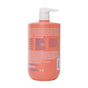 A coral-colored Value Size Daily Lotion bottle from The Seaweed Bath Co with a white pump dispenser highlights its hydrating and soothing qualities with nutrient-rich algae. Ingredients and product details are listed in white and blue on the back label.