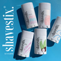 Five Shavestix Solid Shave Stick moisturizing bars with unique illustrated labels are displayed on a blue background, with “shavestix.” in bold white text on the left.