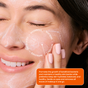 A woman with closed eyes gently applies Shielded Beautys Feeding Frenzy Prebiotic Cleanser, smiling. On-screen text highlights its exfoliating, hydrating, softening, and skin-restoring benefits.