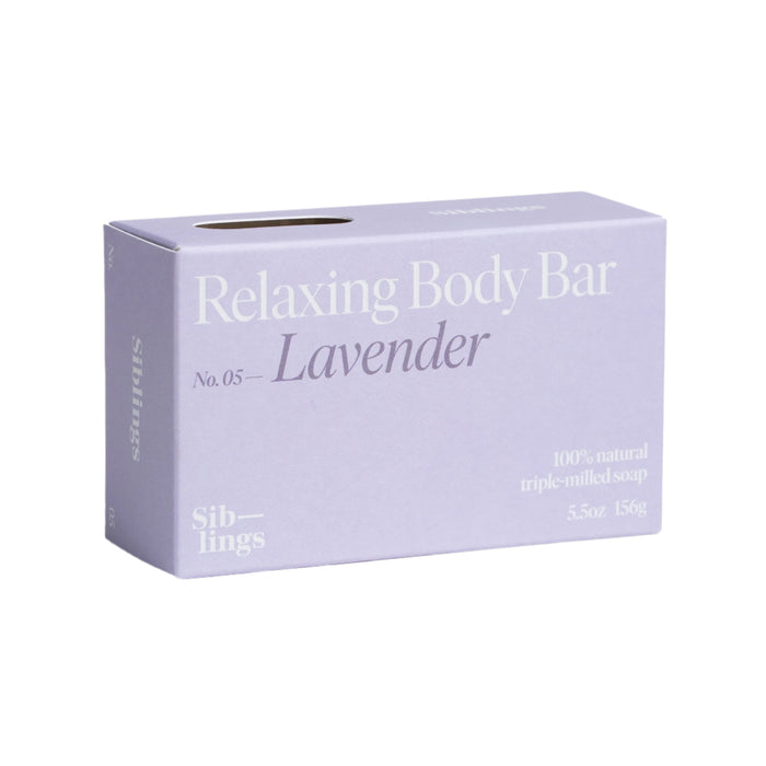 A lavender-colored box is labeled Relaxing Body Bar, No. 05 - Lavender with essential oils to nourish your skin. It contains 100% natural triple-milled soap, weighs 5.5 oz (156 g), and features the brand name Siblings on the sides.