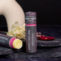 Two Lip Balm Stick: Simply Natural Vegan products by Chagrin Valley Soap & Salve are shown on dark stone—one upright, one open—to highlight this nourishing vegan balm. Decorative flowers are arranged alongside the display.