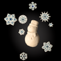 Centered on a black background, a white snowman is surrounded by six blue and white snowflakes—perfect inspiration for the Spinster Sisters Co. Holiday Bath Bomb - Snowman design.
