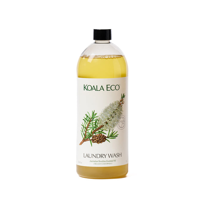A clear plastic bottle of Koala Eco Laundry Wash, containing yellow liquid. The label shows botanical illustrations and highlights that it's made with Australian botanicals and bush lavender, making it ideal for sensitive skin.
