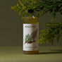 A bottle of Koala Eco Laundry Wash for sensitive skin, with a botanical label, sits on a green surface amid leafy greenery. Experience the fresh scent of Australian bush lavender in every wash.