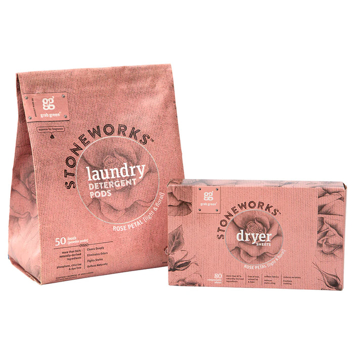 Two pink packages of Grove Collaborative Stoneworks Laundry Pods and Dryer Sheet Kit - Rose Petal, with floral designs: a standing bag of pods and a rectangular box of dryer sheets.