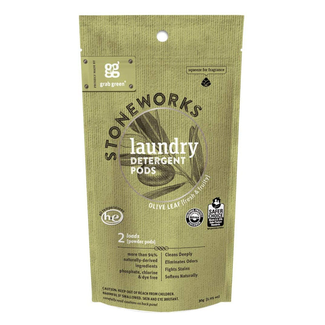 A resealable green bag of grab greens Stoneworks Laundry Detergent Pods - Olive Leaf - Sample deeply cleans with eco-friendly features, containing two pods and showcasing HE compatibility and EPA Safer Choice Certified logos.
