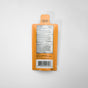 An orange packet of Acure Mineral Sunscreen SPF 50 ($7.99 value) featuring directions, drug facts, and a barcode on the back. The top of the packet reads “Bend here and tear for opening instructions.” The packet is displayed on a plain white background.