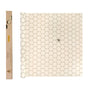 The SuperBee Beeswax Wrap Roll, featuring a white honeycomb hexagon grid with a small bee illustration, sits beside a rectangular brown box with a hexagon window and yellow label—ideal for reusable food storage.