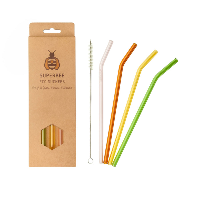 A set of four SuperBee Glass Straws—eco-friendly and reusable—in orange, yellow, green, and clear, plus a cleaning brush, packaged in a brown SuperBee Eco Suckers box with bee logo, all shown on a white background.