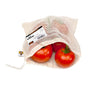 Three red tomatoes in a SuperBee Mesh Produce Bag—an eco-friendly, reusable cotton bag with drawstring and label, featuring a white mesh design that keeps groceries fresh.