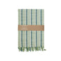 A folded Supra Endura Striped Organic Cotton Tea Towel from the set, featuring green and blue vertical stripes, a fringed edge, and a brown paper band with product details wraps around its middle.