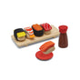 The PlanToys Sushi Play Food Set is a non-toxic wooden set for kids featuring 5 sushi pieces, a soy sauce bottle, and a red dish—brightly colored and perfect for sustainable pretend play.