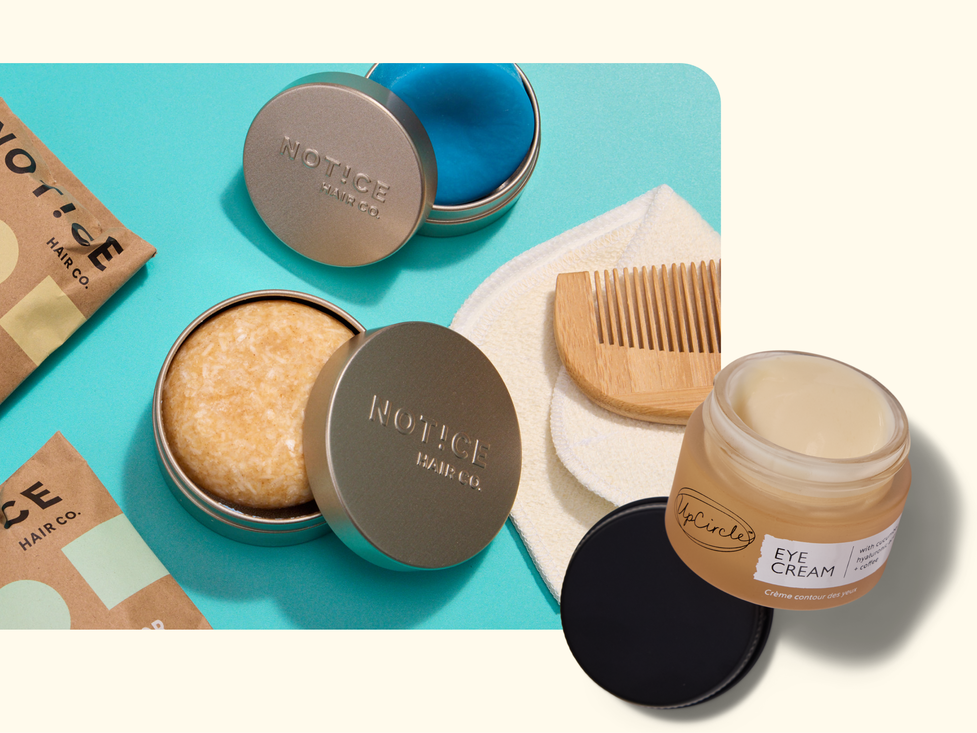 A shampoo bar in a tin, a solid conditioner in another tin, a wooden comb, a white reusable pad, brown product pouches, and an open jar of eye cream with a black lid are arranged on pastel backgrounds.