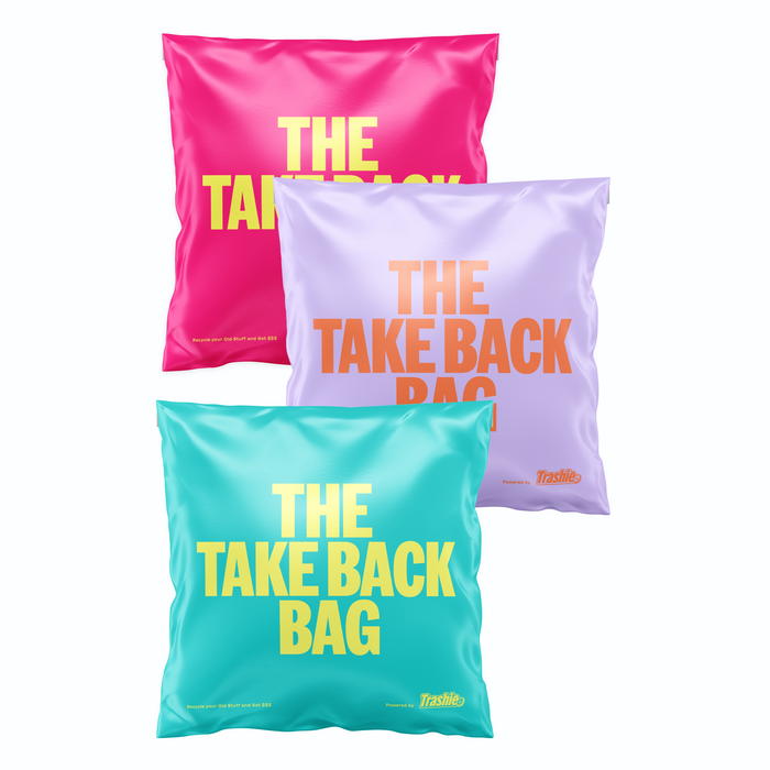 The Trashie Take Back Bag 3-pack features vibrant pink, lavender, and teal bags with bold yellow lettering. The Trashie logo is proudly displayed at the bottom right of each bag. These stylish bags are perfect for collecting unwanted clothing and meeting your recycling needs.