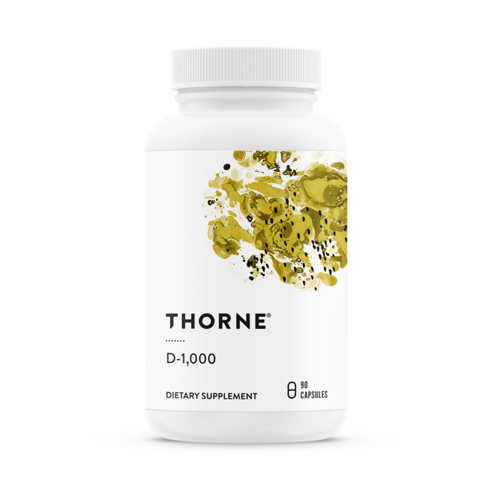 A bottle of Thorne Vitamin D-1,000 contains 90 capsules of vitamin D3. It features a white plastic design with black text and an abstract gold and black splash, promoting immune function and supporting cardiovascular health.