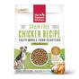 A bag of The Honest Kitchen Dry Dog Food, Grain Free Chicken Whole Food Clusters, with dog, chicken, and veggie illustrations. Labels show its human grade, grain free, and minimally processed.