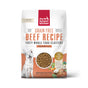 A white bag of The Honest Kitchen Dry Dog Food, Grain Free Beef Whole Food Clusters, features a dog illustration, a clear window with whole food clusters, and images of beef and vegetables at the bottom right.
