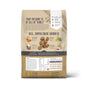 Back of The Honest Kitchen Dry Dog Food, Whole Grain Chicken Whole Food Clusters bag features whole food clusters with chicken, carrots, spinach, kibble pieces, nutrition chart, and product benefits on a beige background.