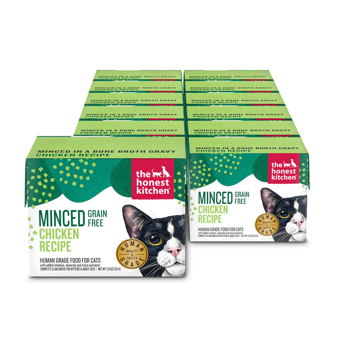 A stack of twelve green and white boxes of The Honest Kitchen Minced Wet Cat Food Chicken in Bone Broth Gravy, featuring a gold “Human Grade” seal with a cat’s face on the front.