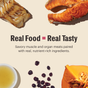 Cooked wild-caught salmon & cod fillet, pumpkin, cranberries, and oil surround the text: Real Food = Real Tasty. The Honest Kitchen Minced Wet Cat Food Salmon & Cod in Fish Broth Gravy blends muscle and organ meats with nutrient-rich ingredients for balanced nutrition.
