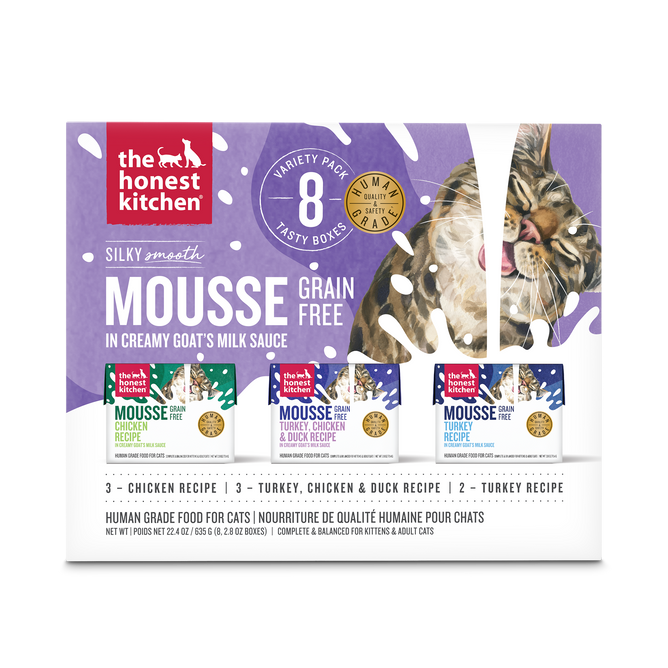 A box of The Honest Kitchen Mousse Wet Cat Food - Cat Mousse with Goats Milk, Variety Pack, contains 8 packs with chicken, turkey, and duck recipes. The packaging shows a cat licking its lips.