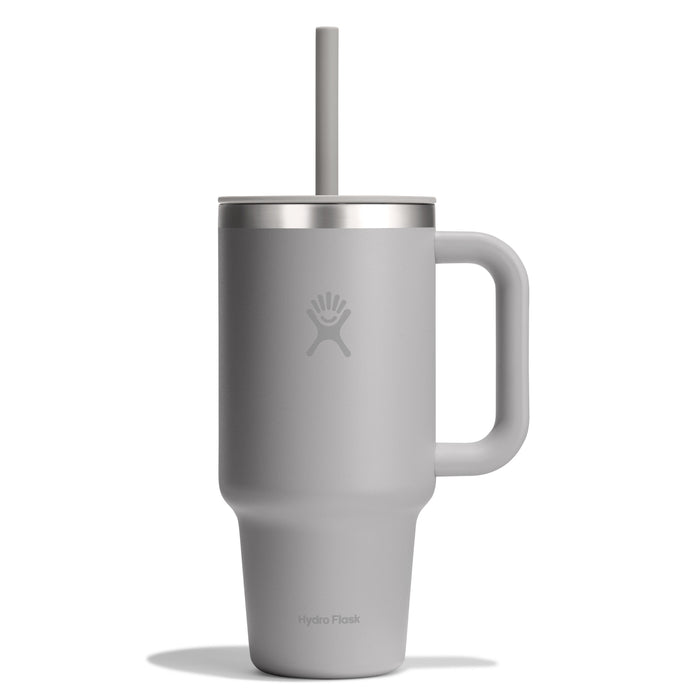 The 32 oz Hydro Flask Travel Tumbler in gray, featuring a handle and straw, is depicted with a sleek matte finish and the Hydro Flask logo. Its double-wall vacuum insulation keeps beverages at the optimal temperature for longer.