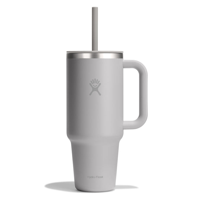 The Hydro Flask Travel Tumbler, 40 oz, is a grey insulated tumbler with a handle and leak-resistant lid featuring a straw. It highlights the Hydro Flask logo with double-wall vacuum insulation for a sleek, modern look.